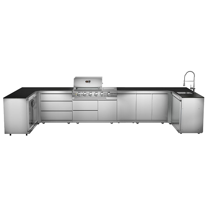 Outdoor kitchen with generous preparation space facing a dining table