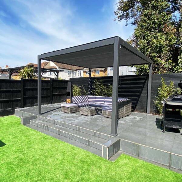 Adjustable pergola louvres casting considered shade across an outdoor table